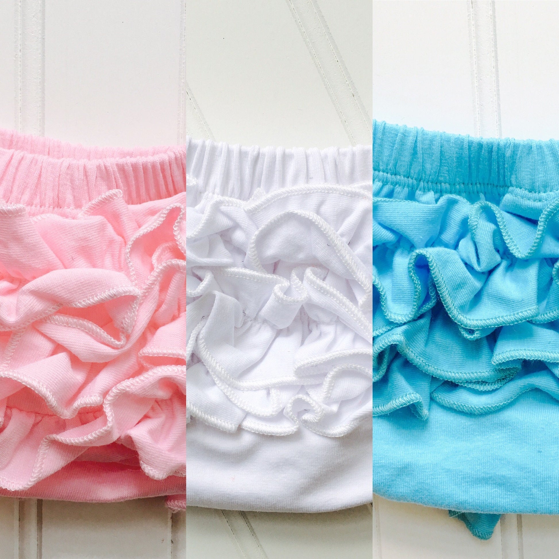 4 Colors Full Cotton Baby Bloomer with Cotton Back Ruffles. Color options are Pink, White, Cool White, and Ocean Blue. Baby Toddler