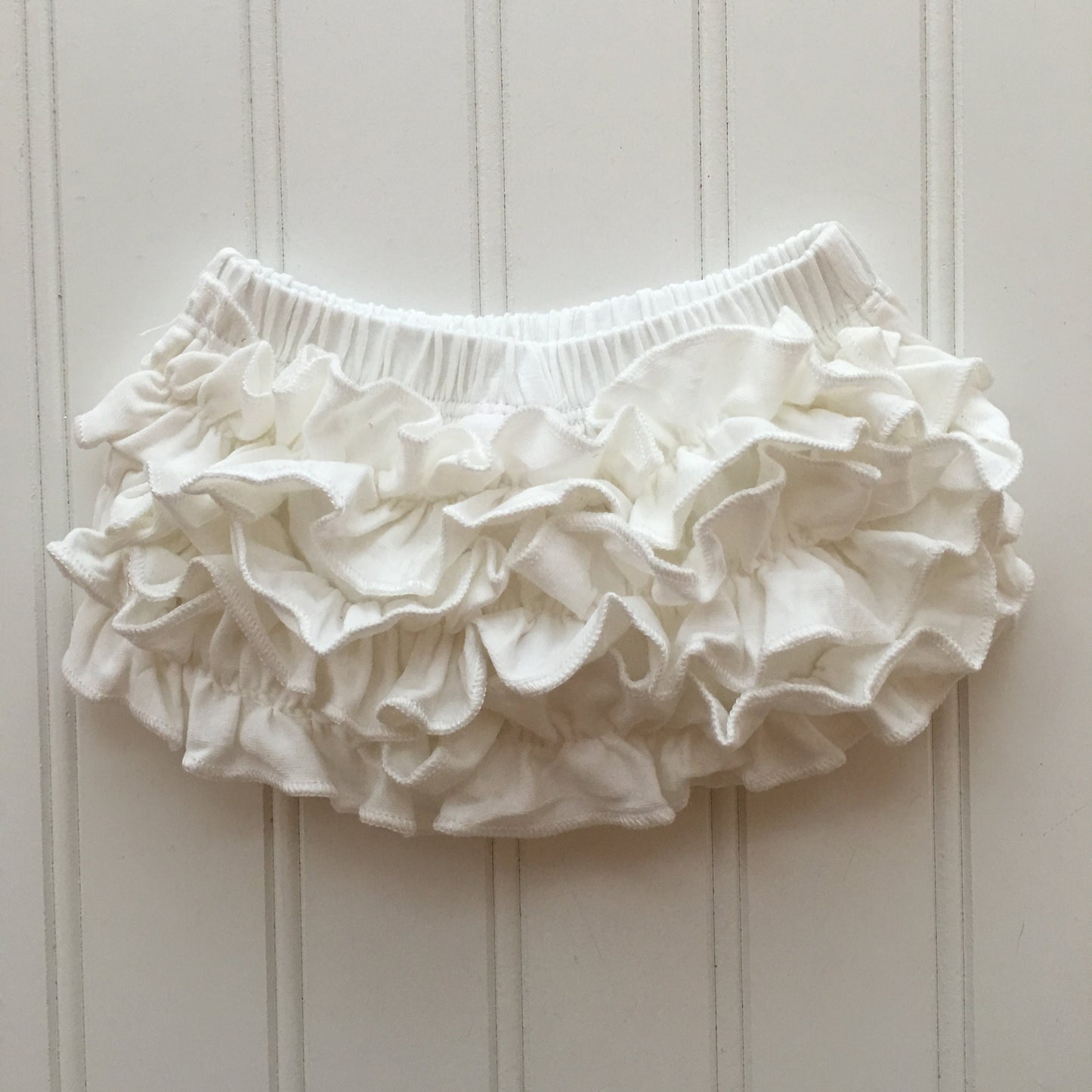 4 Colors Full Cotton Baby Bloomer with Cotton Back Ruffles. Color options are Pink, White, Cool White, and Ocean Blue. Baby Toddler